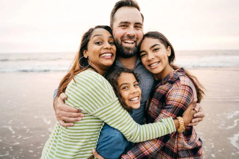 Parents and two children smiling together while planning orthodontic care in Central Florida