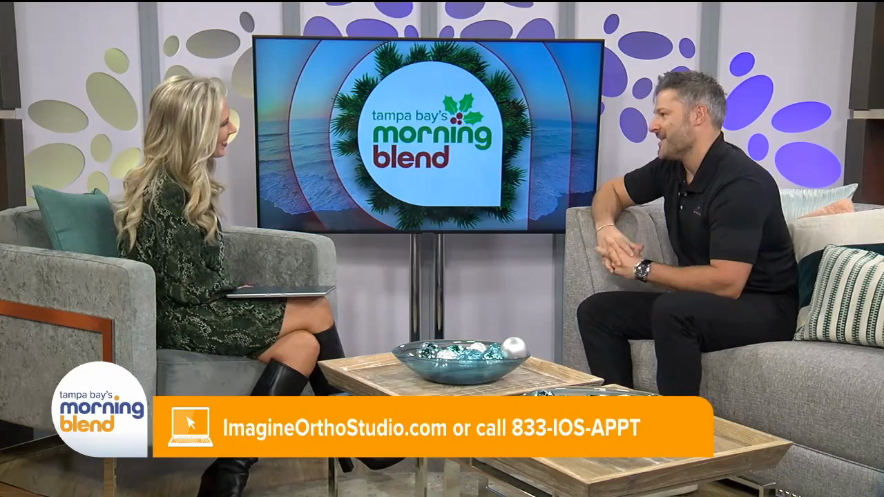 Woman and man discussing orthodontic services on Tampa Bay's Morning Blend, featuring Imagine Orthodontic Studio branding and contact information for scheduling consultations.