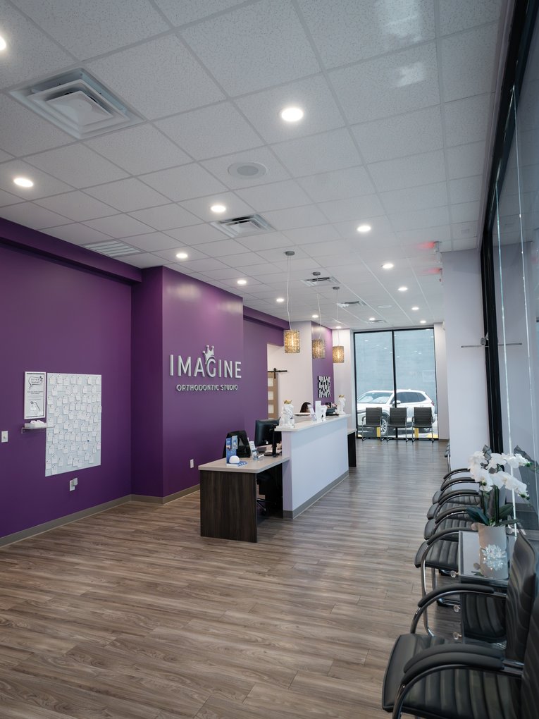 Reception desk and waiting area at the Imagine Orthodontic Studio office in Orlando, FL